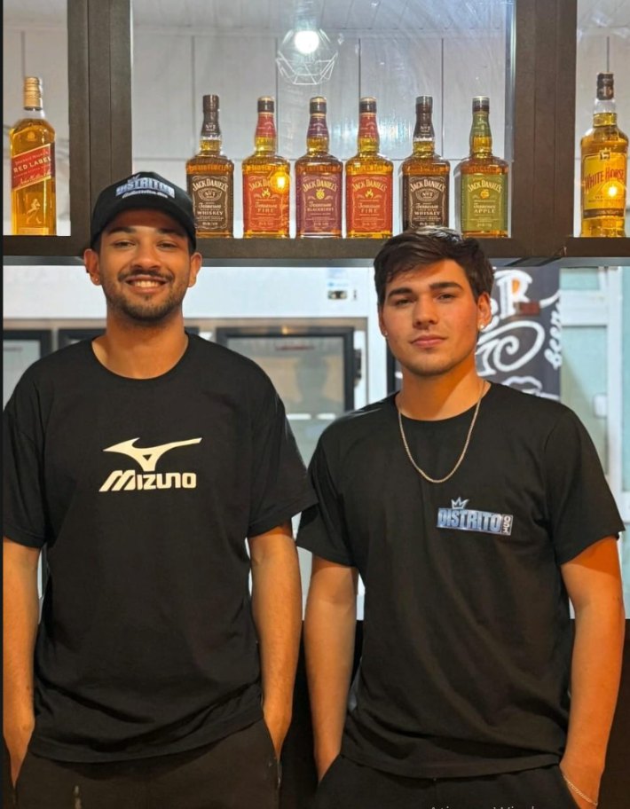 Os dois sócios da Distrito 051 atrás do balcão da loja